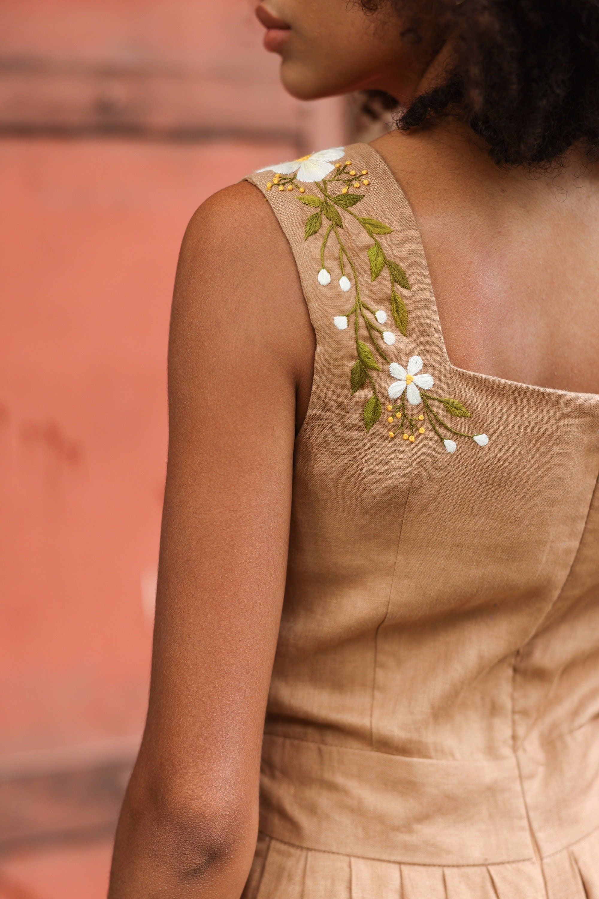 Close-up of a dress with floral embroidery on a blurred background