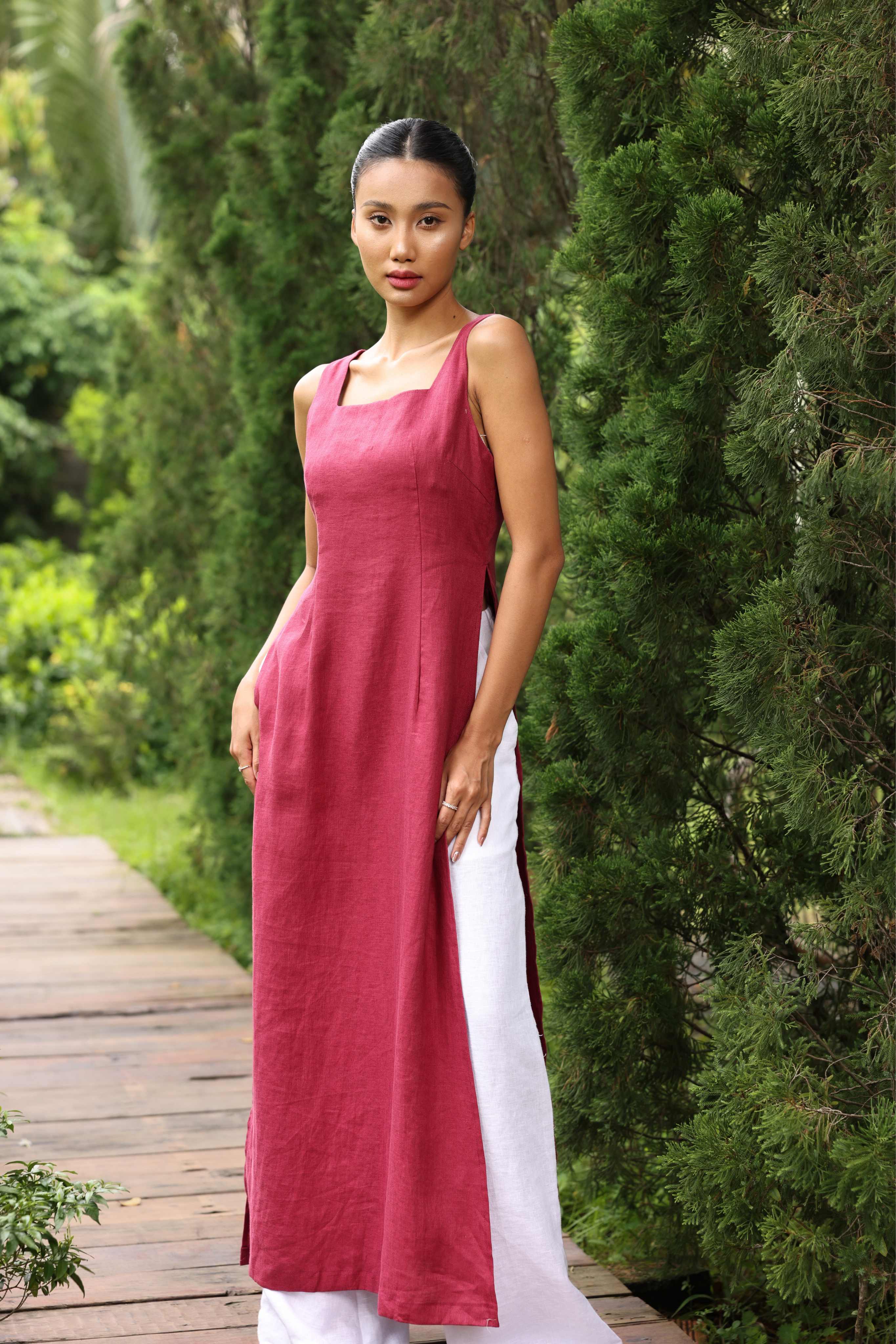 Woman wearing a pink dress standing in a garden