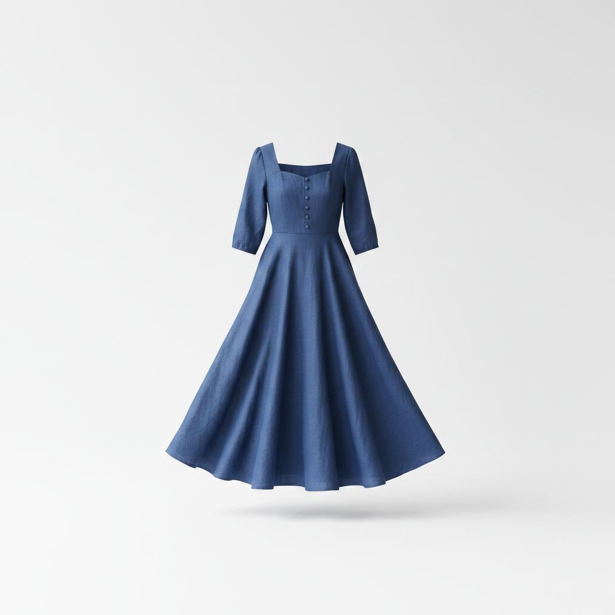 A blue dress with a full skirt and three-button bodice is shown against a plain white background.