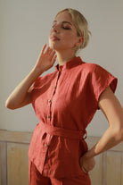 Woman wearing an outfit against a plain background