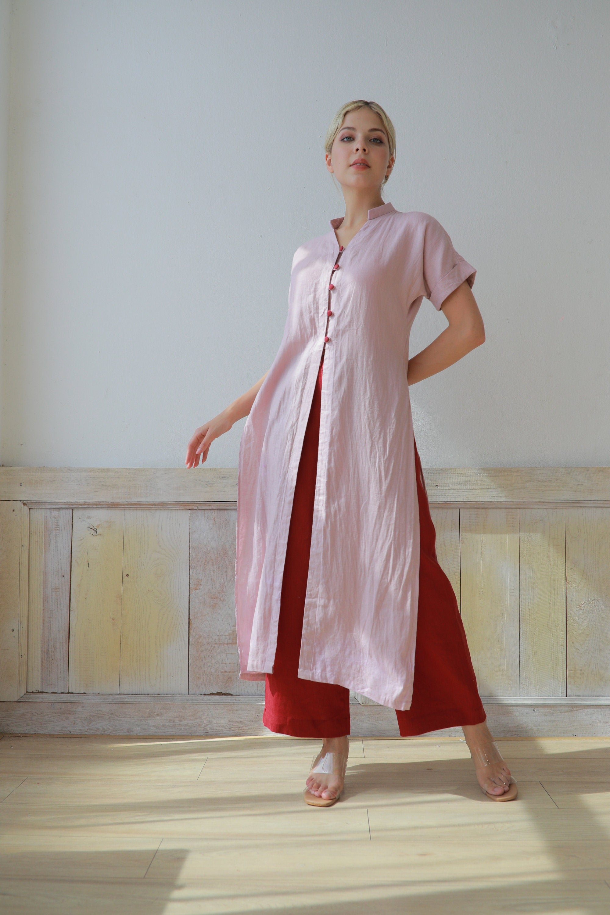 Woman wearing a pink dress with a white background