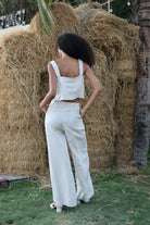 Woman in an outfit standing in front of hay bales