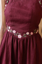 A dress with floral embroidery on a plain background