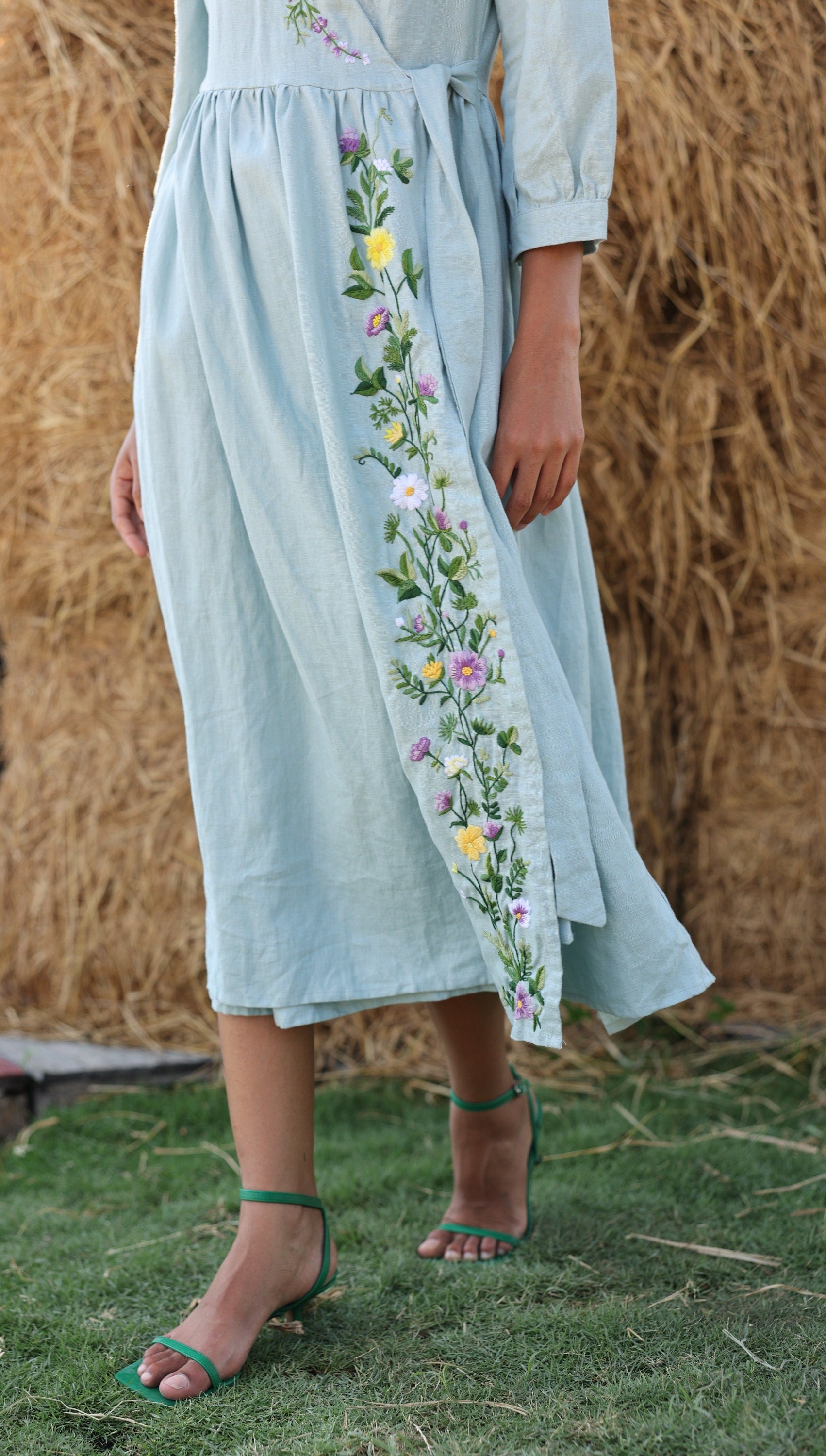 Light blue dress with floral embroidery on a natural background