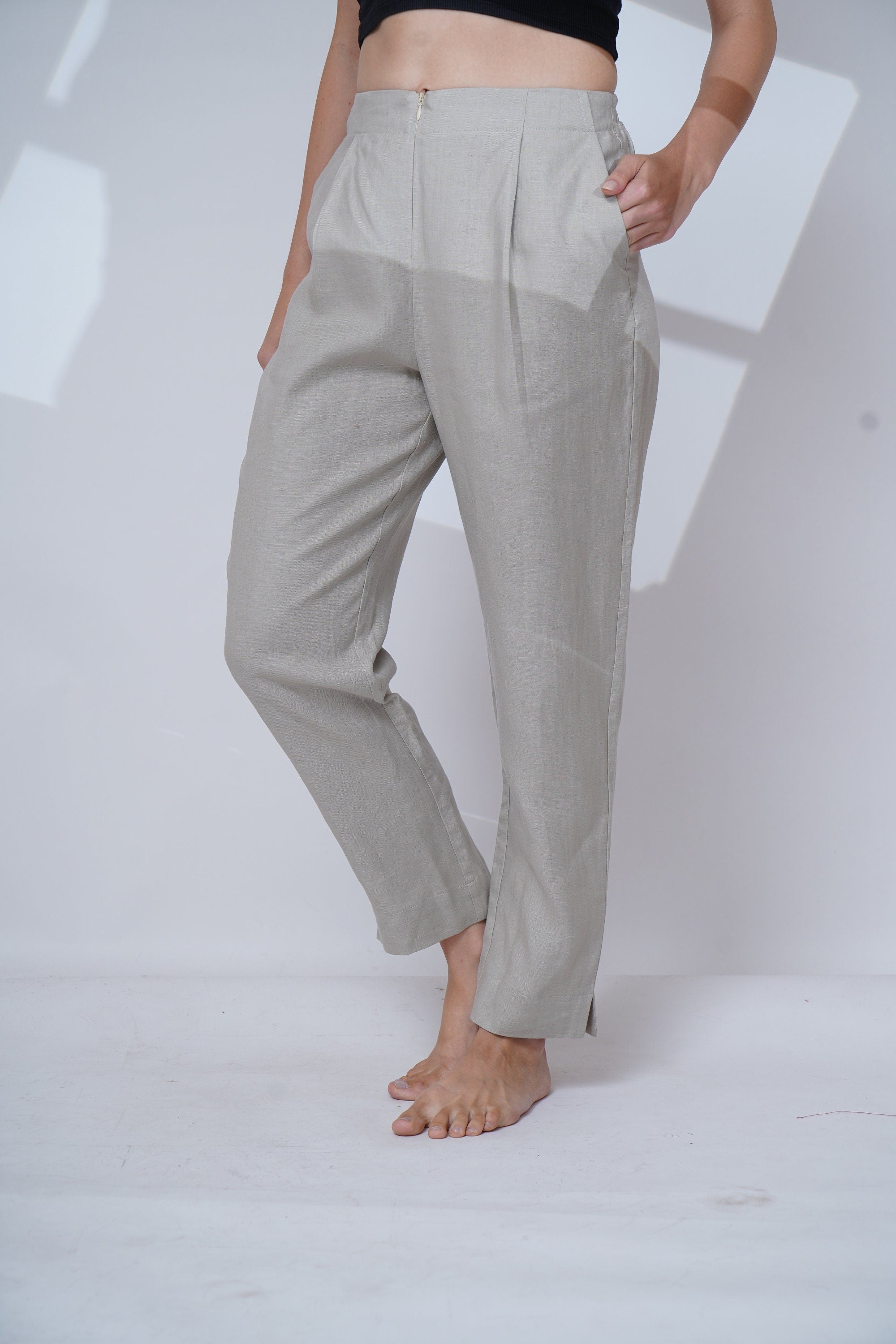 Light gray pants worn by a person on a white background