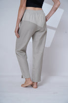 Light gray pants worn by a person on a white background