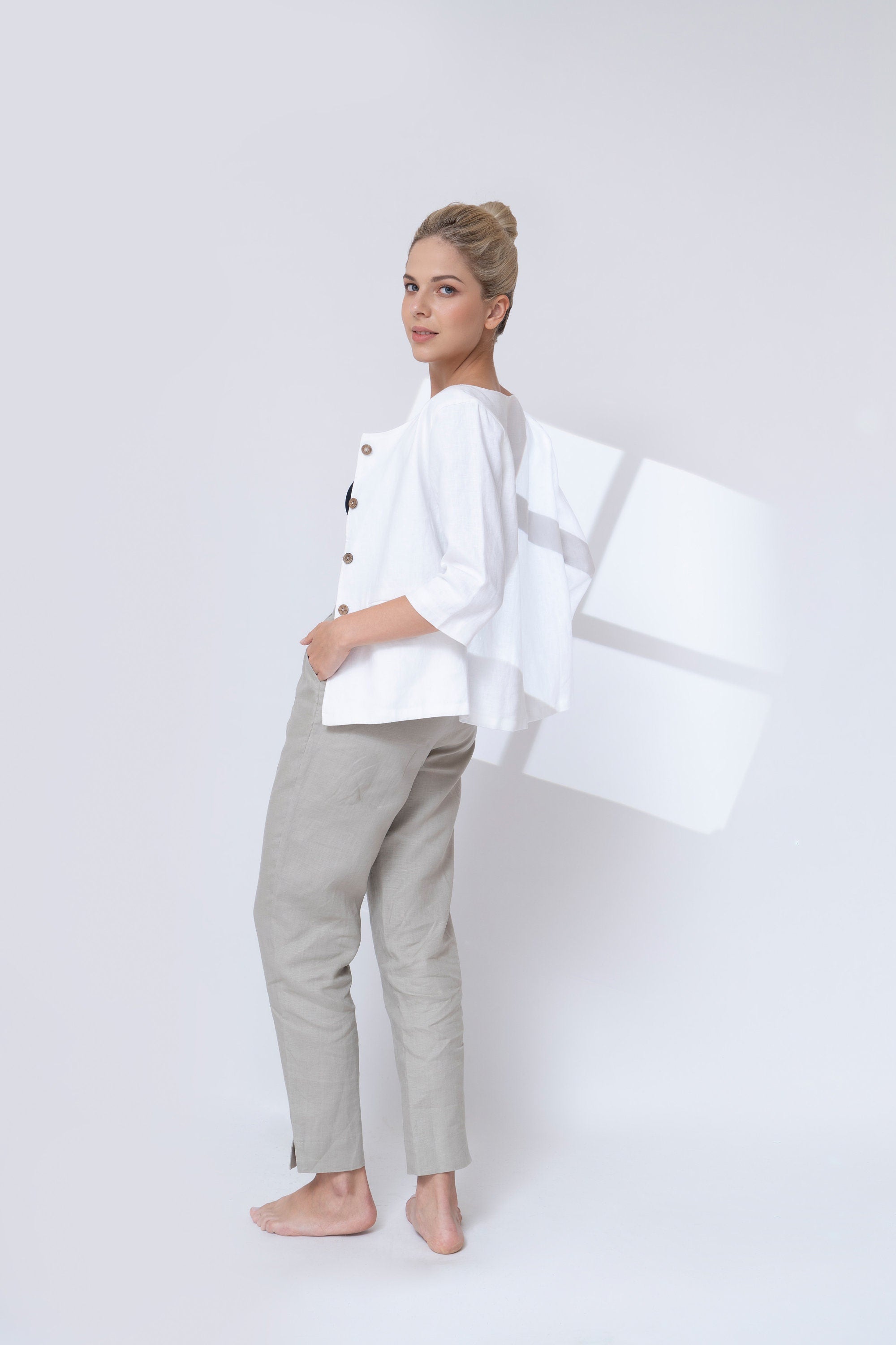 Woman wearing a white jacket on a white background