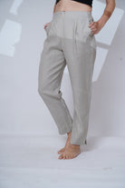 Light gray pants worn by a person on a white background