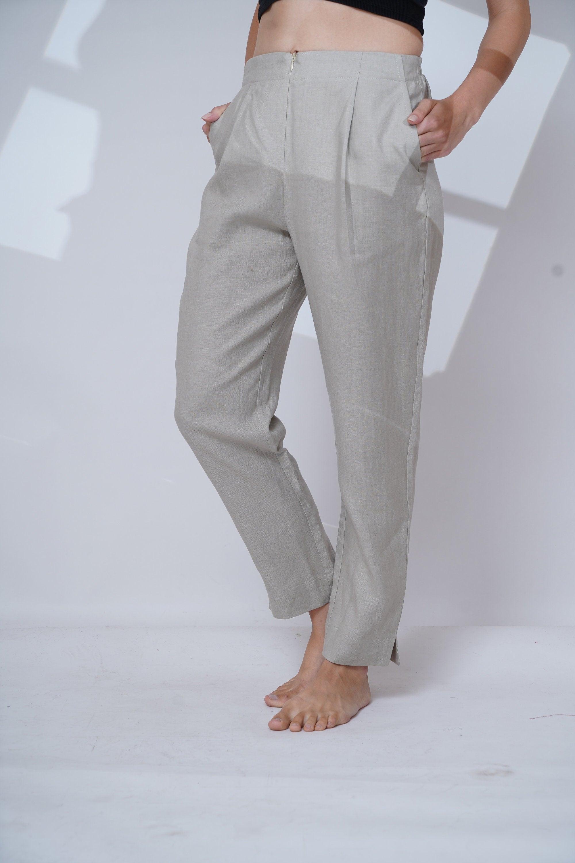 Light gray pants worn by a person on a white background