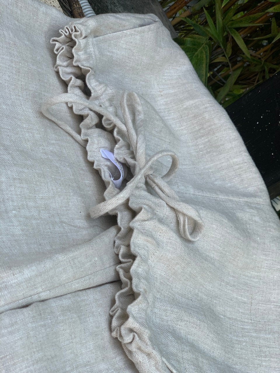 Light gray fabric with ruffled trim on a chair