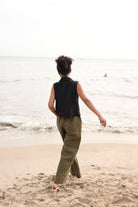 Person walking on a beach with ocean waves in the background