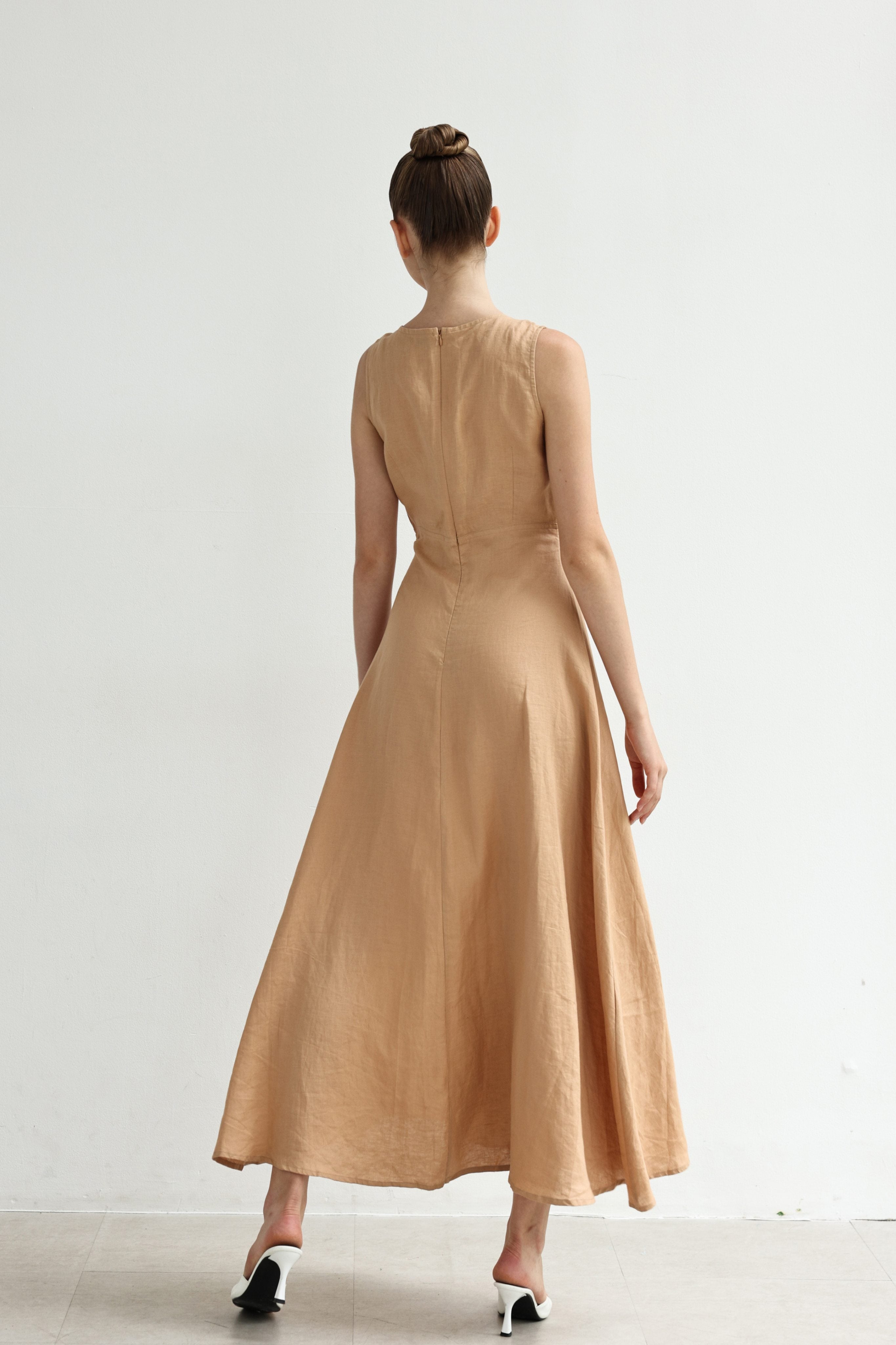 Woman wearing a dress standing against a white background