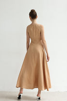Woman wearing a dress standing against a white background