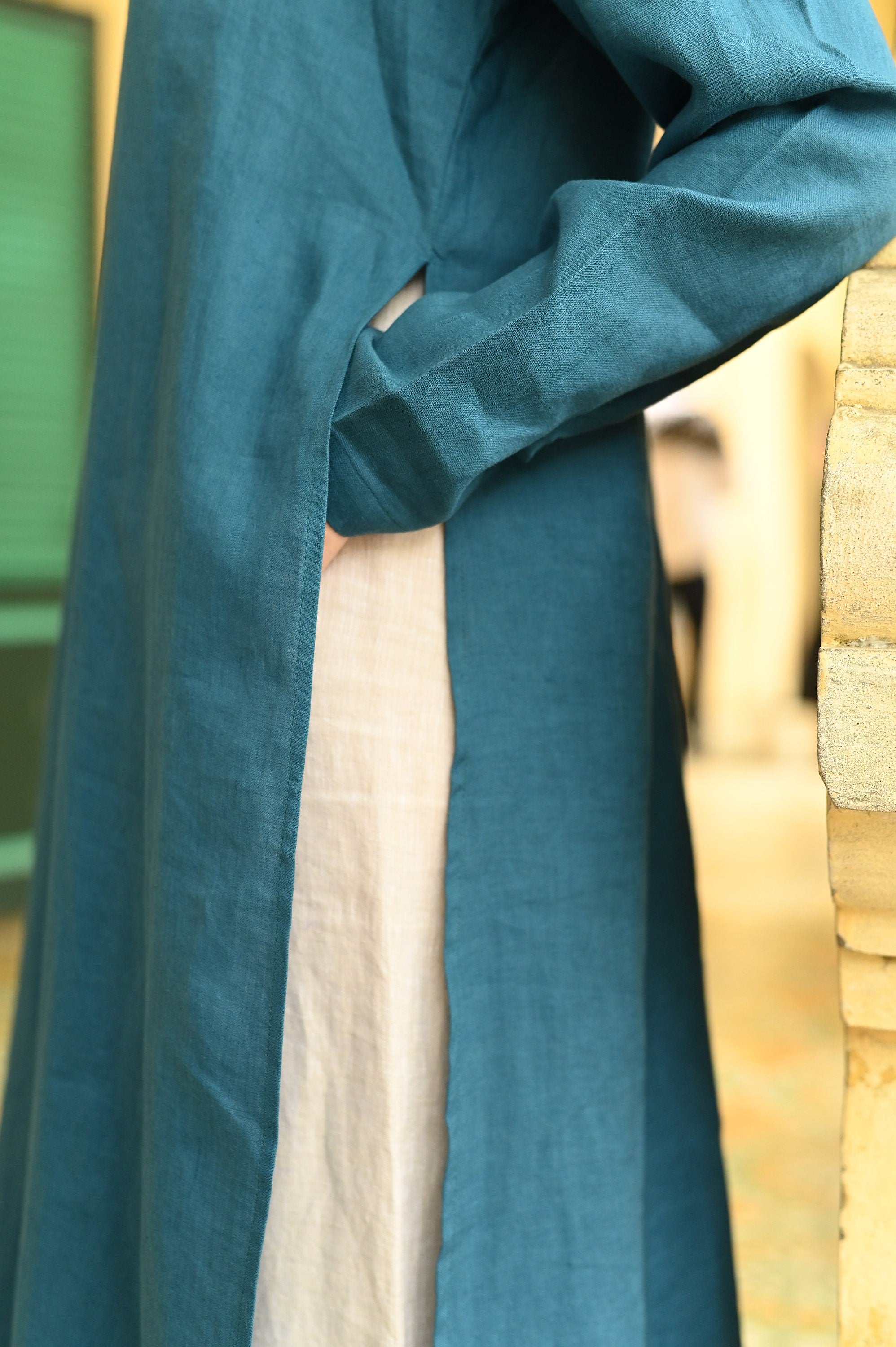 Teal fabric with a textured pattern on a blurred background